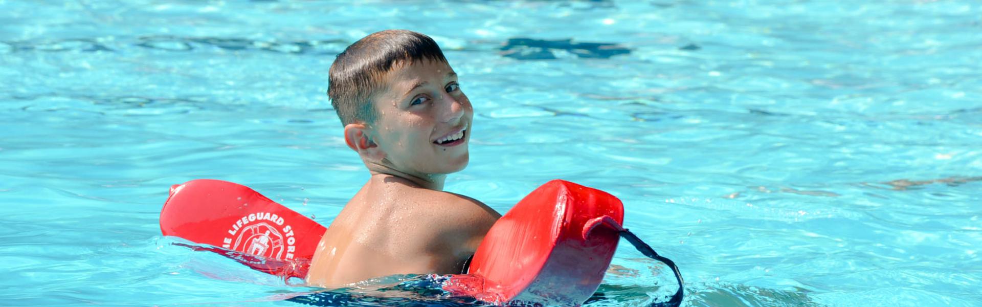 Boy Swimming with Floaters